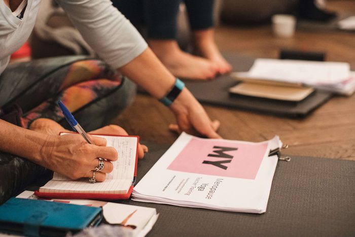 Yoga for menopause women writing in books