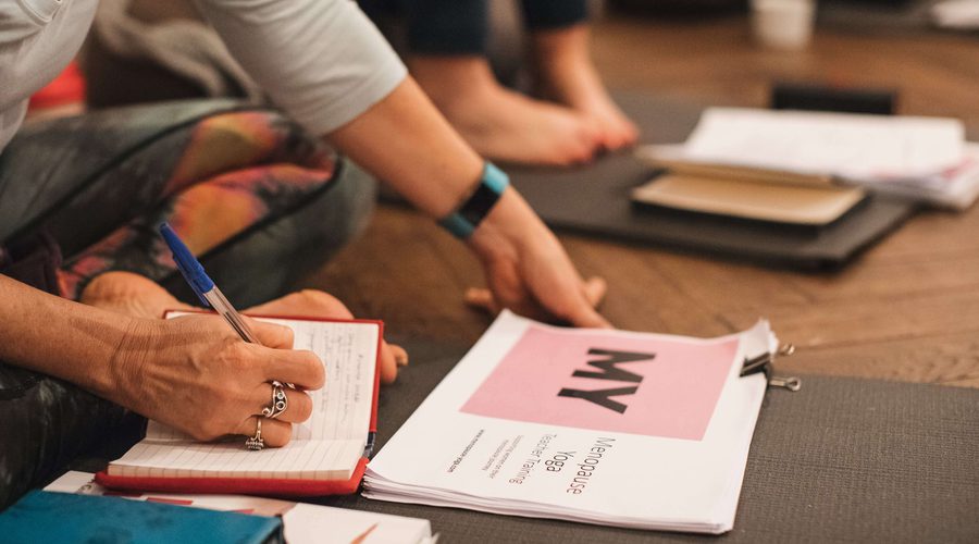 Yoga for menopause women writing in books